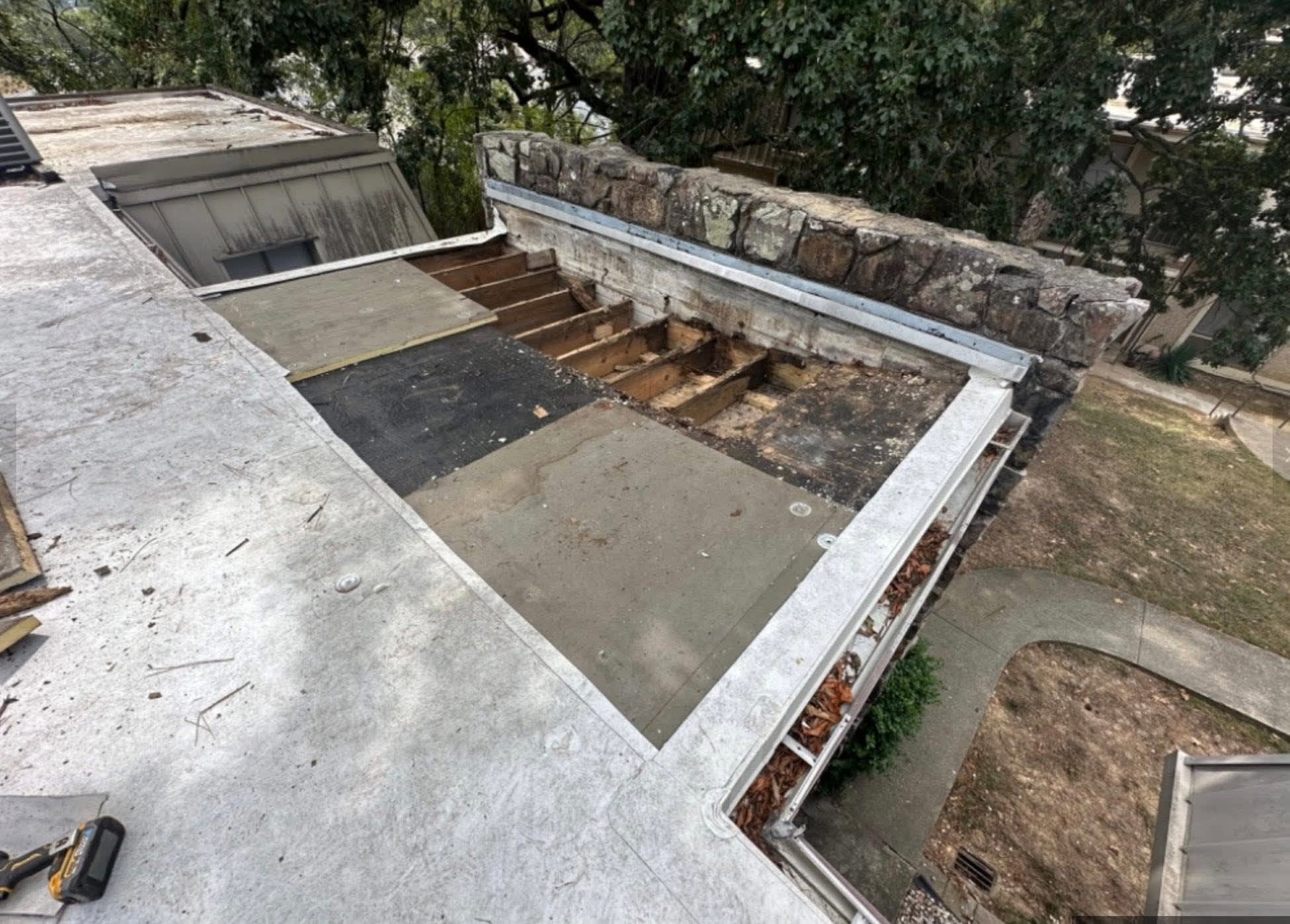 Skylight area before repair — damaged decking exposed